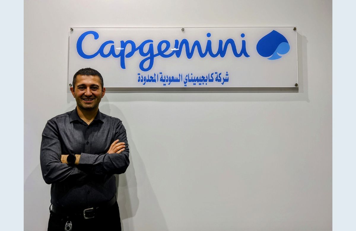 Shamil posing in front of Capgemini Saudi Arabia Sign